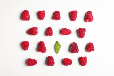 Composition with delicious ripe raspberries on white background, top view