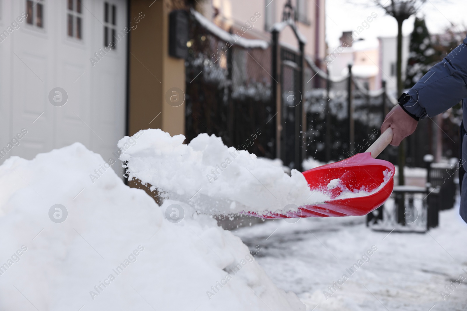 Photo of Man shoveling snow on city street, closeup