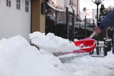 Man shoveling snow on city street, closeup