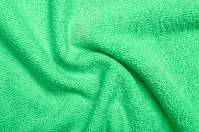 Crumpled light green microfiber cloth as background, closeup