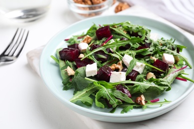 Photo of Fresh delicious beet salad on white table, closeup