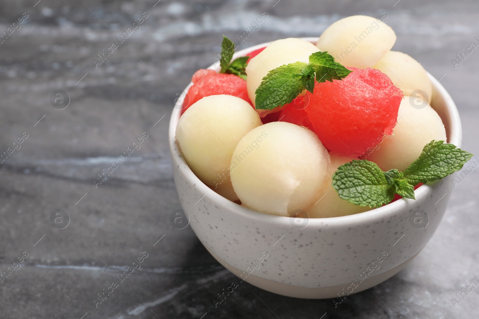 Photo of Bowl with melon and watermelon balls on table