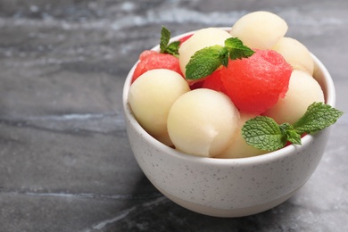 Bowl with melon and watermelon balls on table