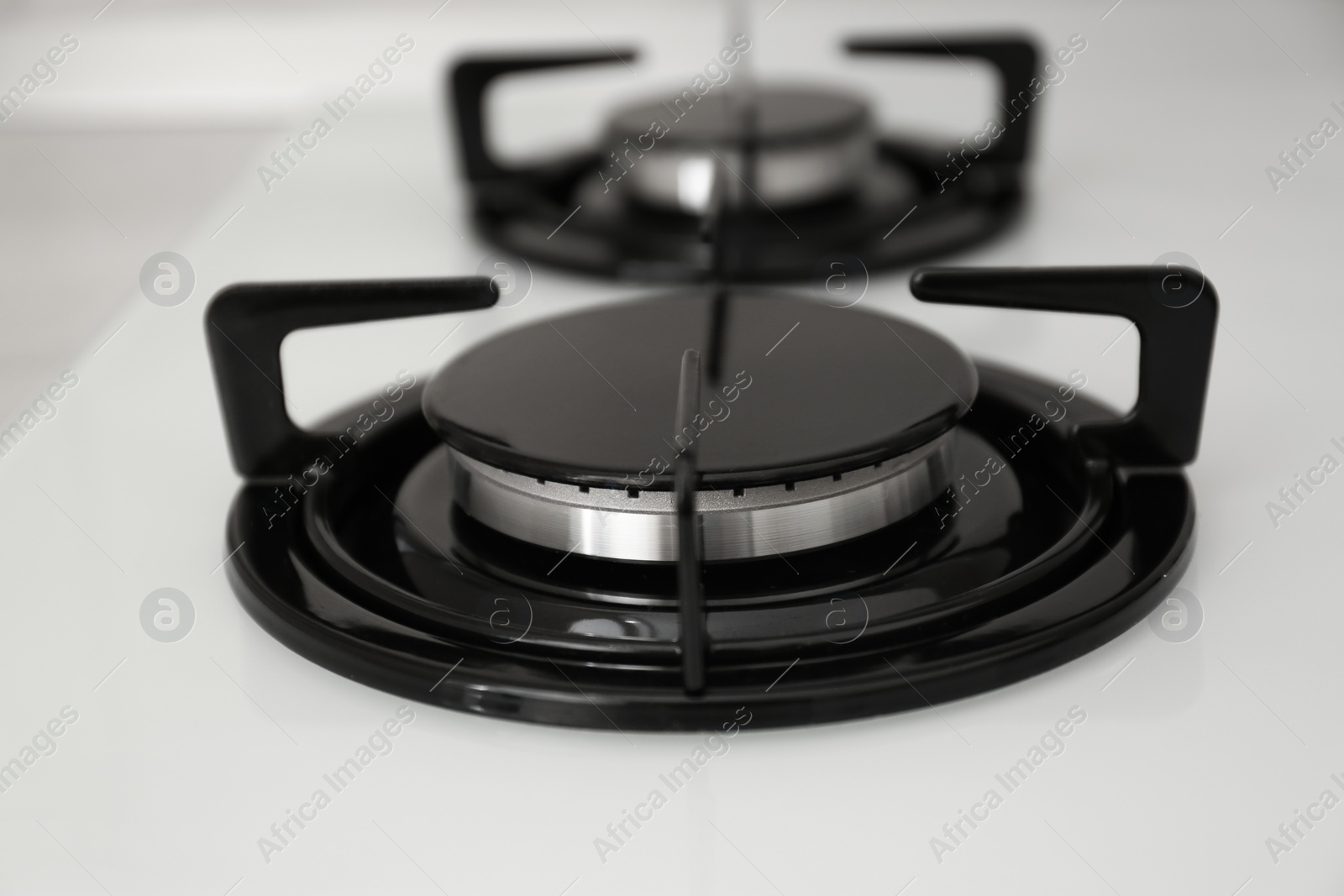 Photo of Modern built-in gas cooktop, closeup. Kitchen appliance