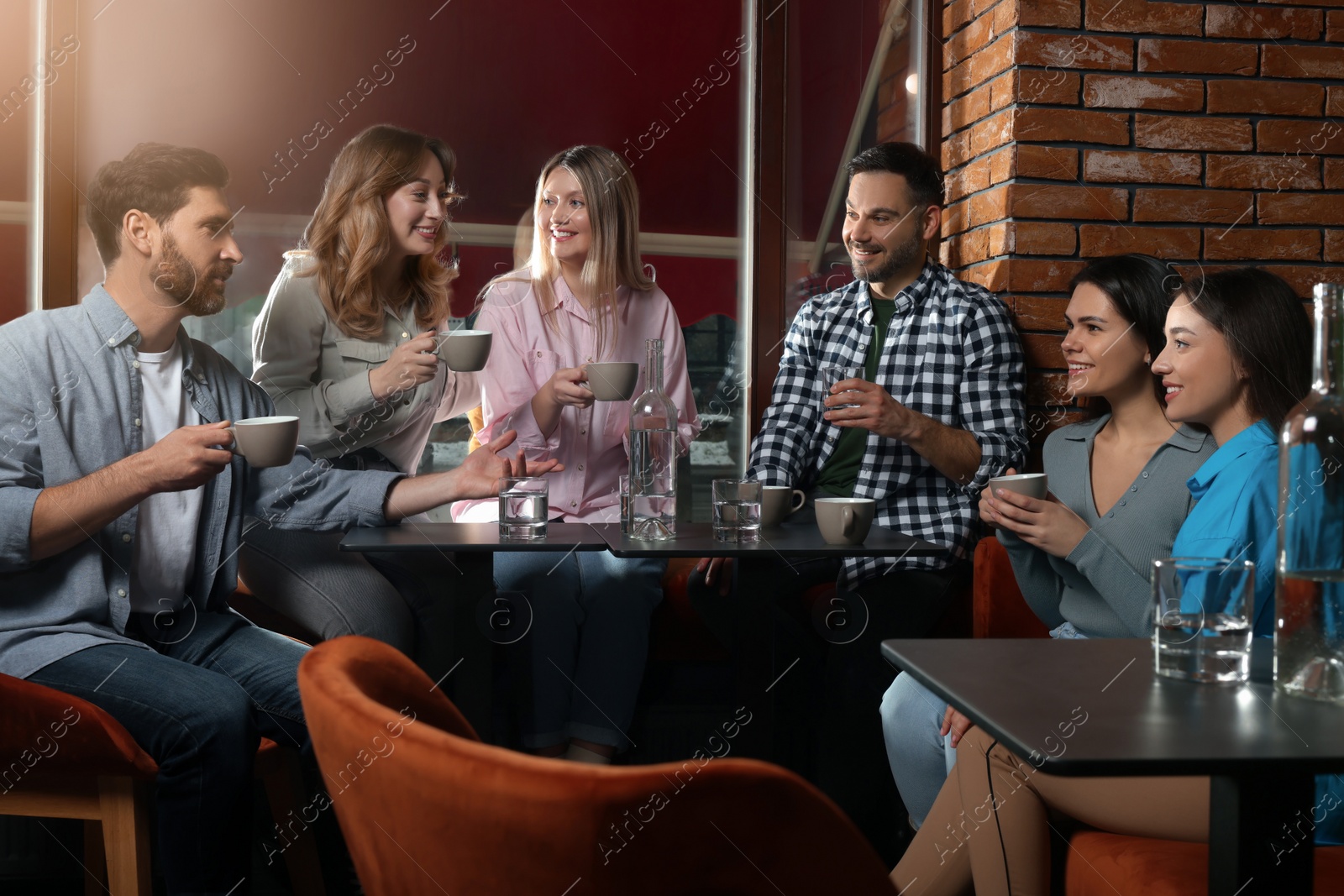 Photo of Friends with coffee spending time together in cafe