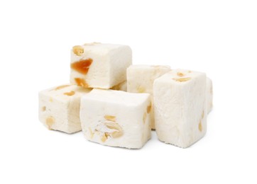 Photo of Pieces of delicious nougat on white background