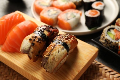 Photo of Different tasty sushi rolls on table, closeup