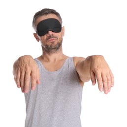 Man with eye mask in sleepwalking state on white background