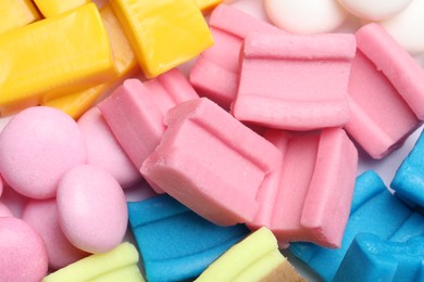 Photo of Different tasty colorful bubble gums as background, closeup