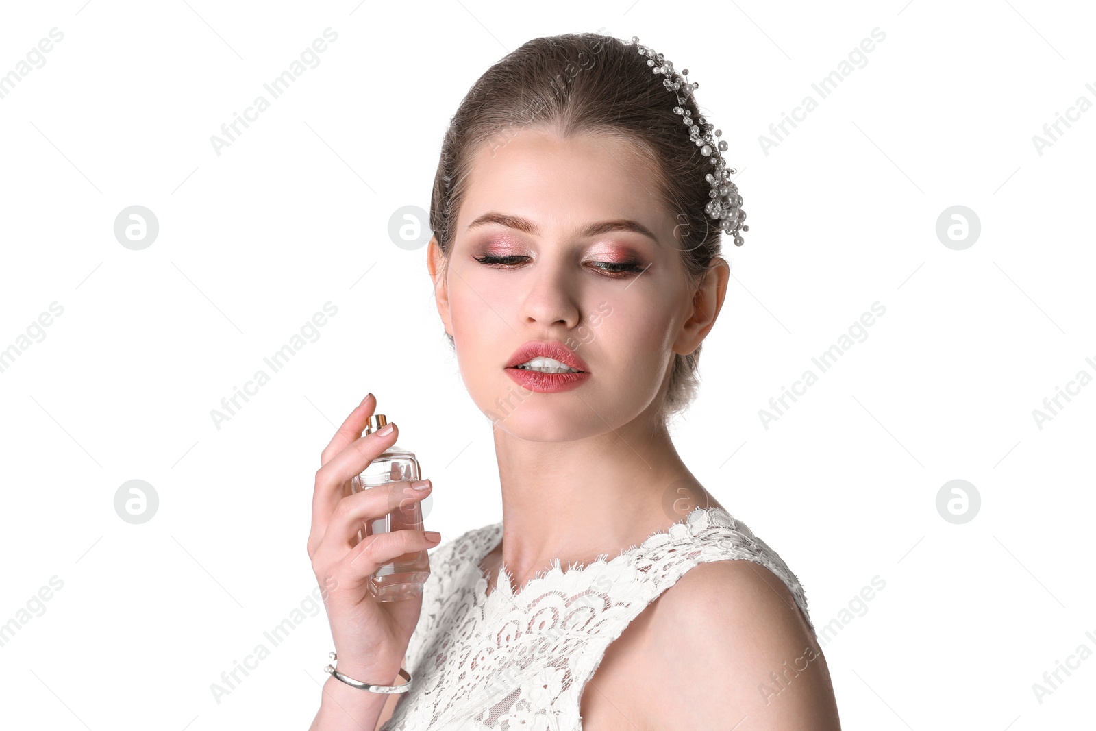 Photo of Beautiful young bride with bottle of perfume on white background