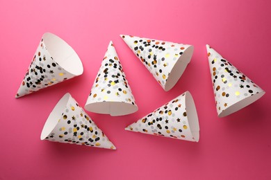 Photo of Beautiful party hats on pink background, top view