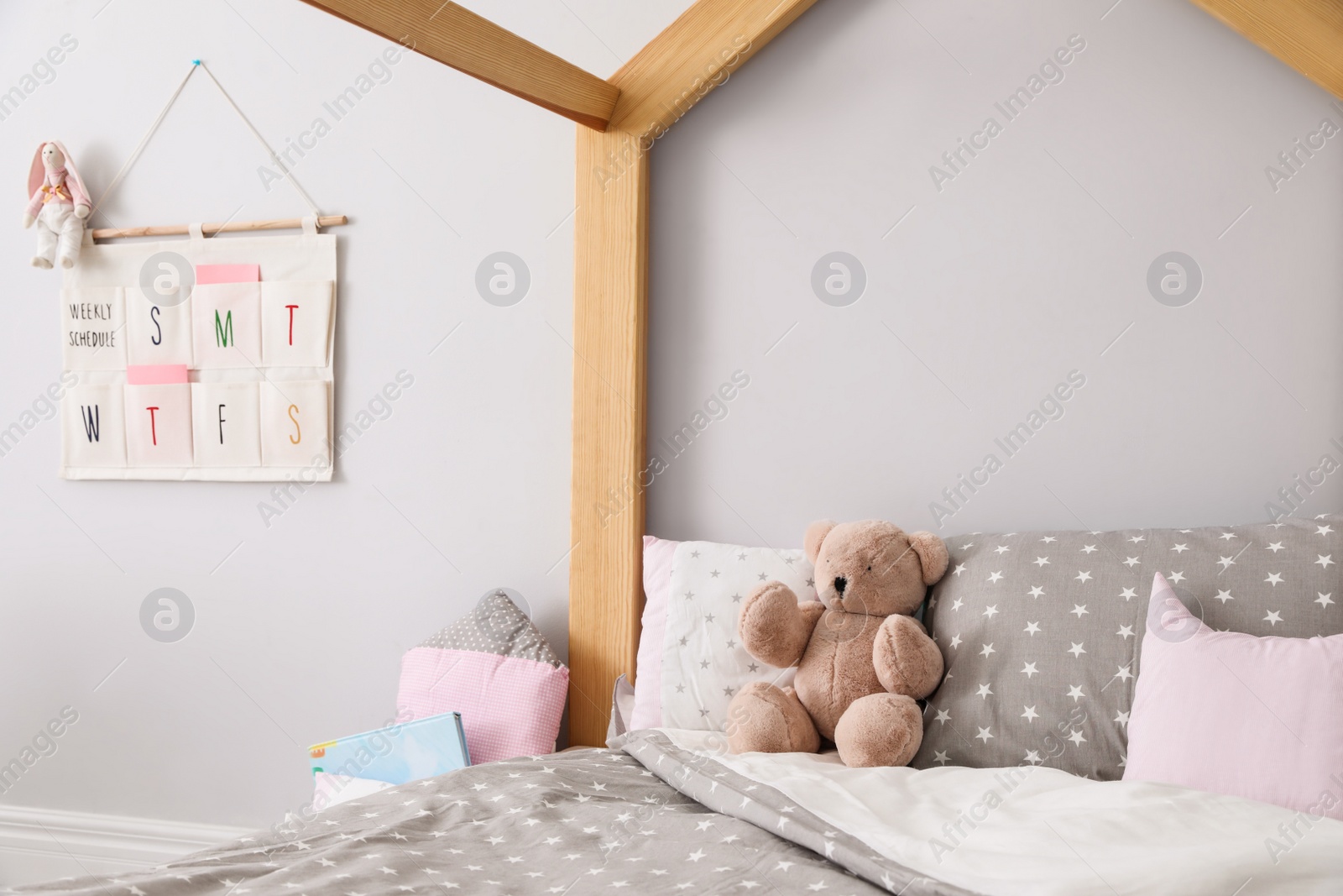 Photo of Stylish child room interior with comfortable bed