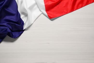 Photo of Flag of France on white wooden background, top view. Space for text