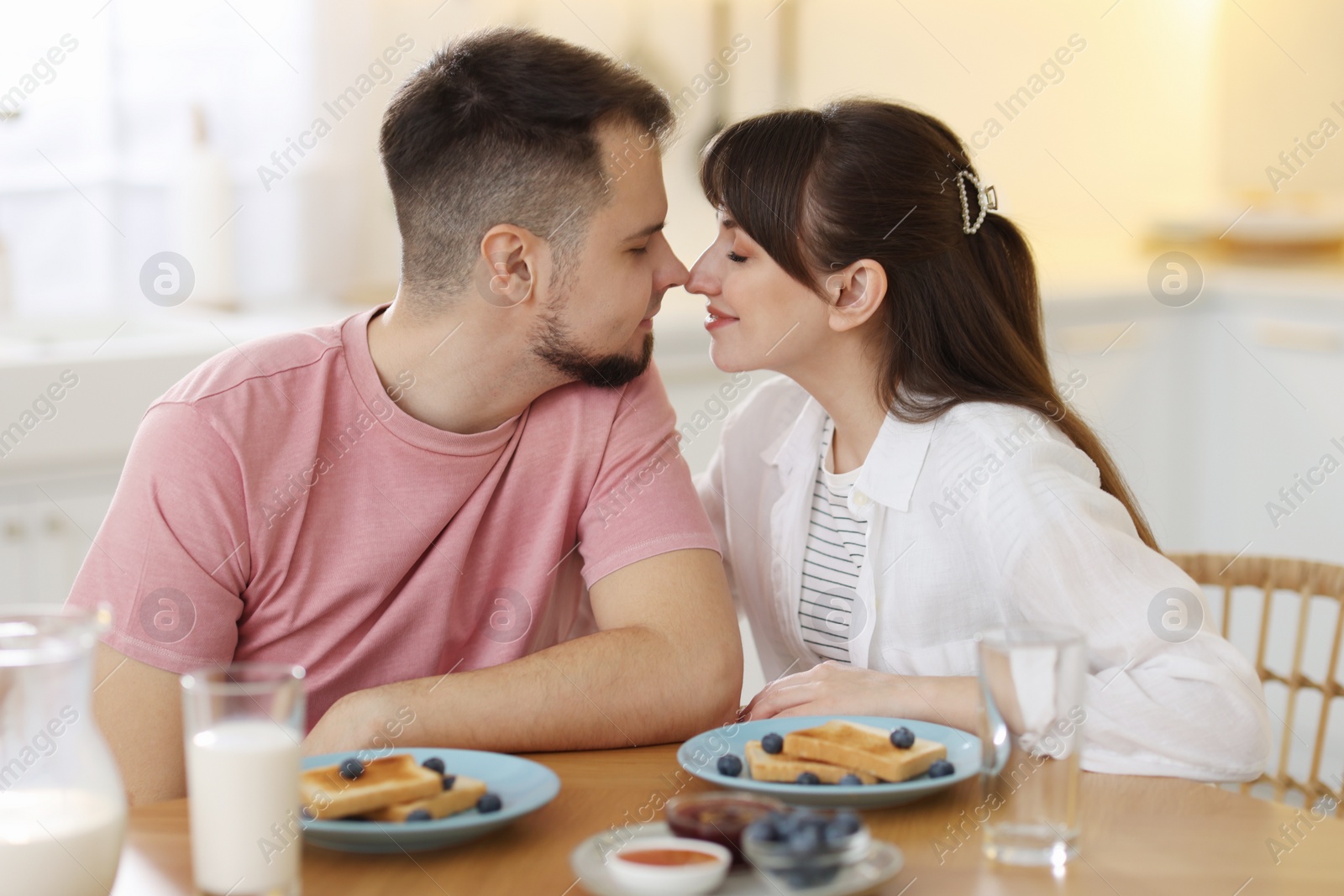 Photo of Lovely couple spending time together during breakfast at home