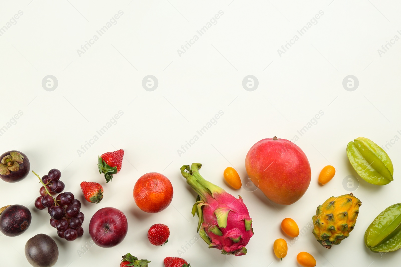 Photo of Assortment of fresh exotic fruits on white background, flat lay. Space for text