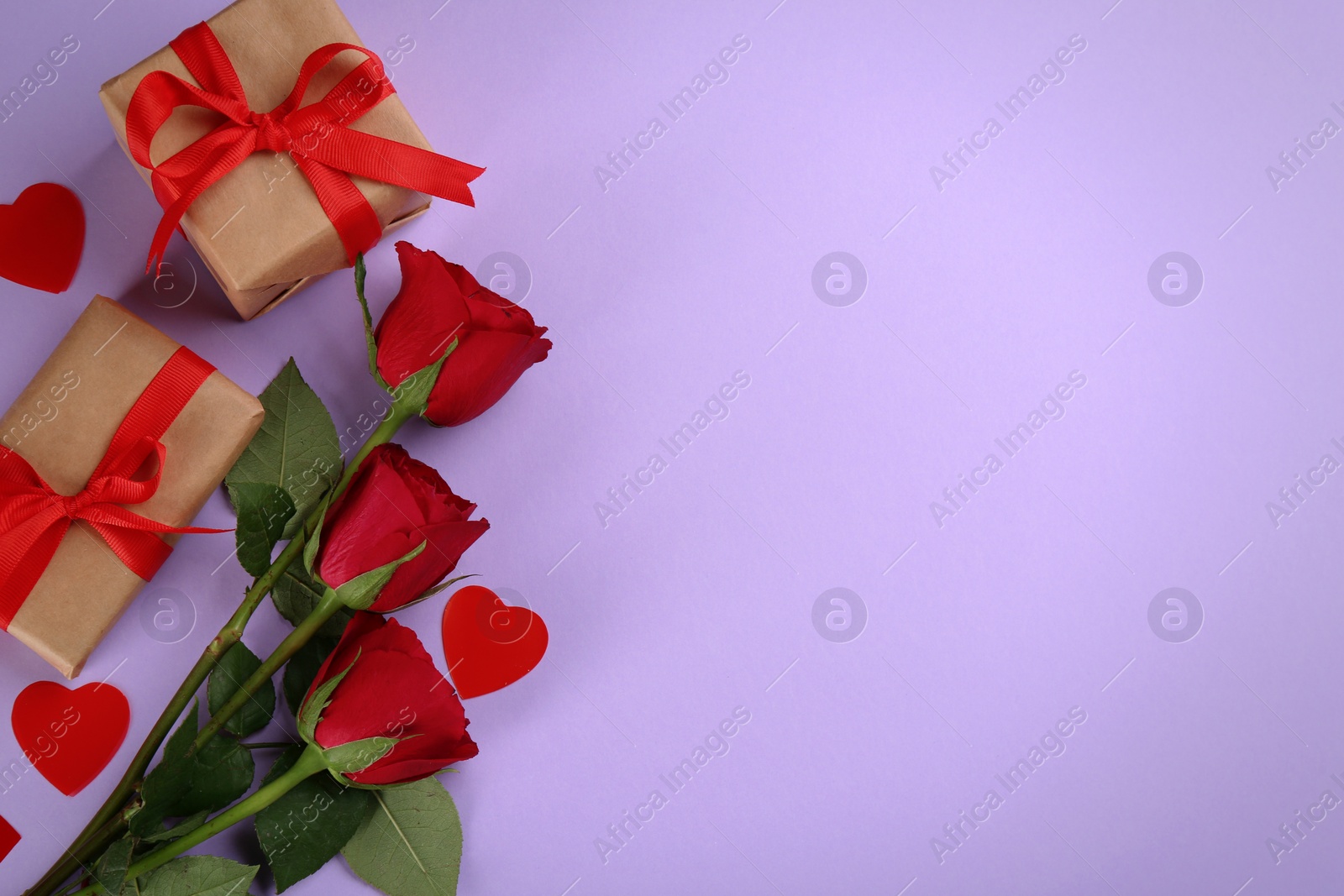 Photo of Gift boxes, roses and hearts on violet background, flat lay with space for text. Valentine's Day celebration