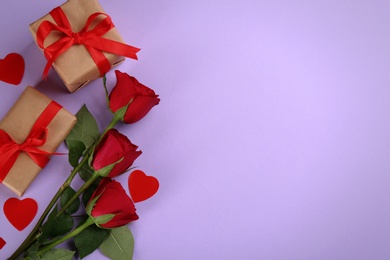 Photo of Gift boxes, roses and hearts on violet background, flat lay with space for text. Valentine's Day celebration