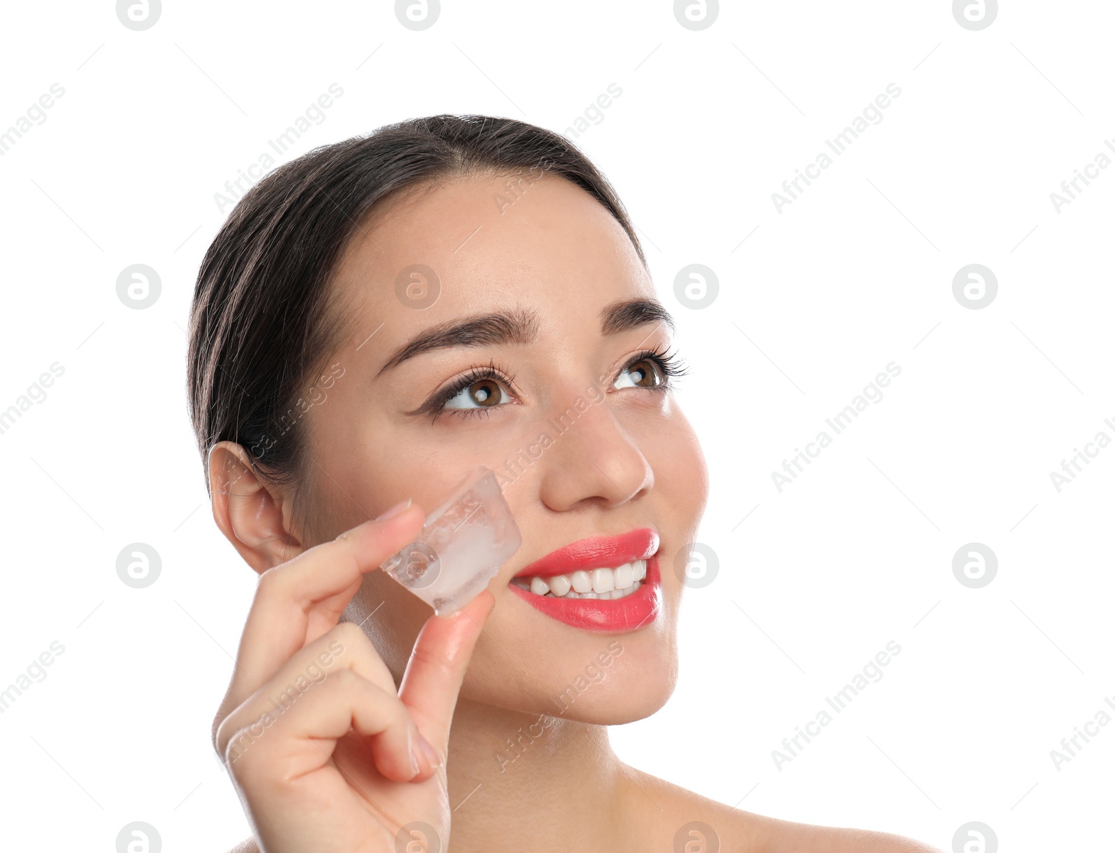 Photo of Young woman with ice cube on white background. Skin care