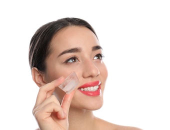 Young woman with ice cube on white background. Skin care