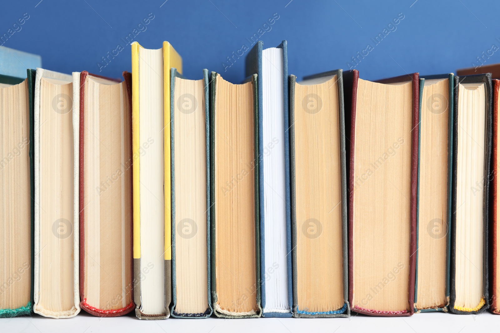 Photo of Collection of old books on white shelf