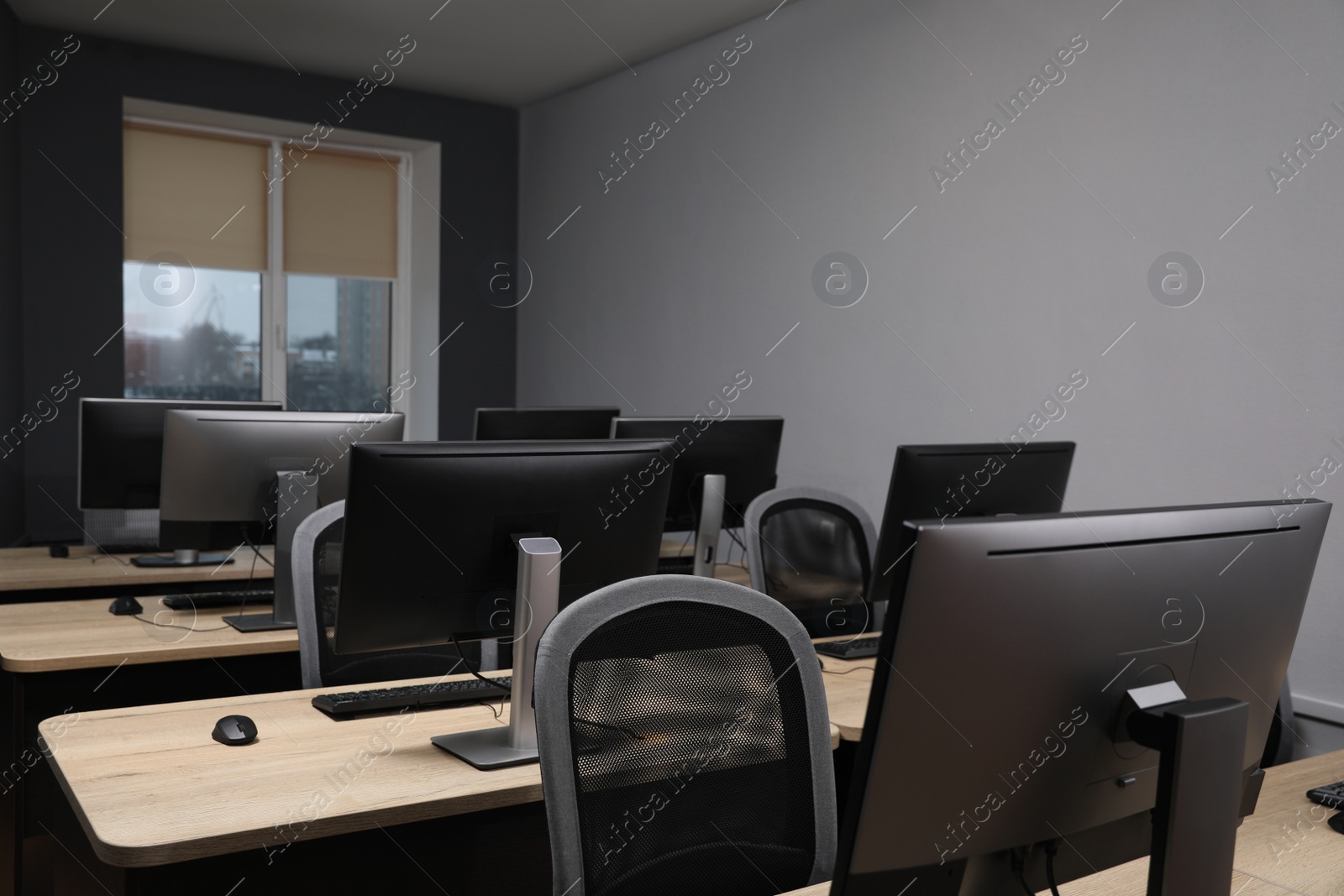 Photo of Many modern computers in open space office