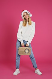 Photo of Happy woman with vintage radio and headphones on pink background. Christmas music