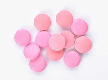 Photo of Color pills on white background, top view. Medical care