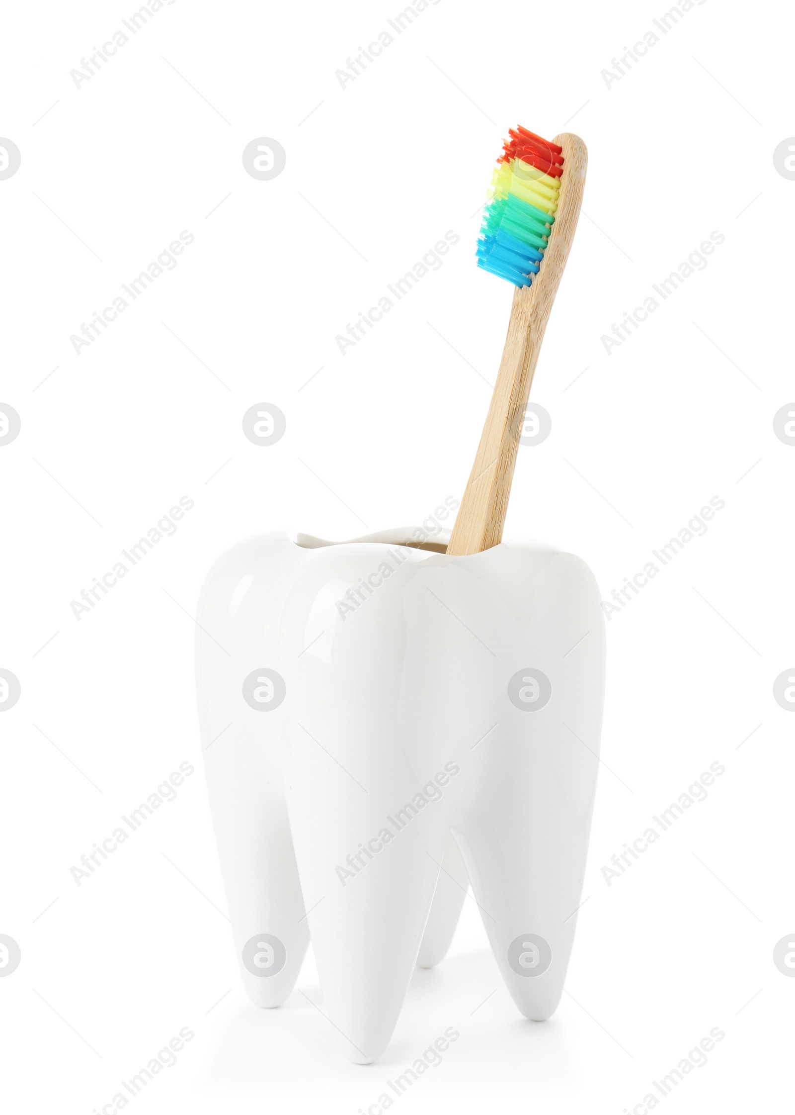 Photo of Tooth shaped holder with brush on white background