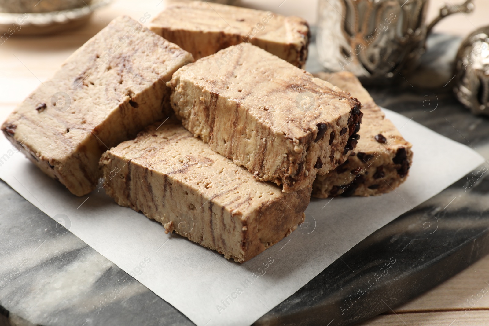 Photo of Tasty chocolate halva on wooden table, closeup