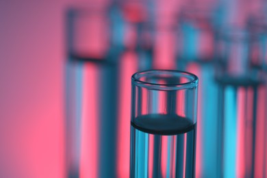 Glass test tube on color background, closeup