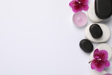 Flat lay composition with spa stones and flowers on white background, space for text