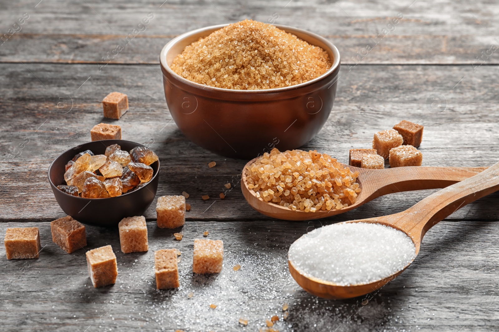 Photo of Composition with different types of sugar on wooden table