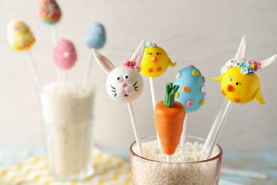 Delicious sweet cake pops for Easter celebration on light background, closeup