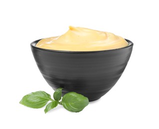 Photo of Tasty cheese sauce and basil on white background