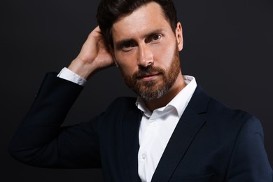Portrait of handsome bearded man on black background