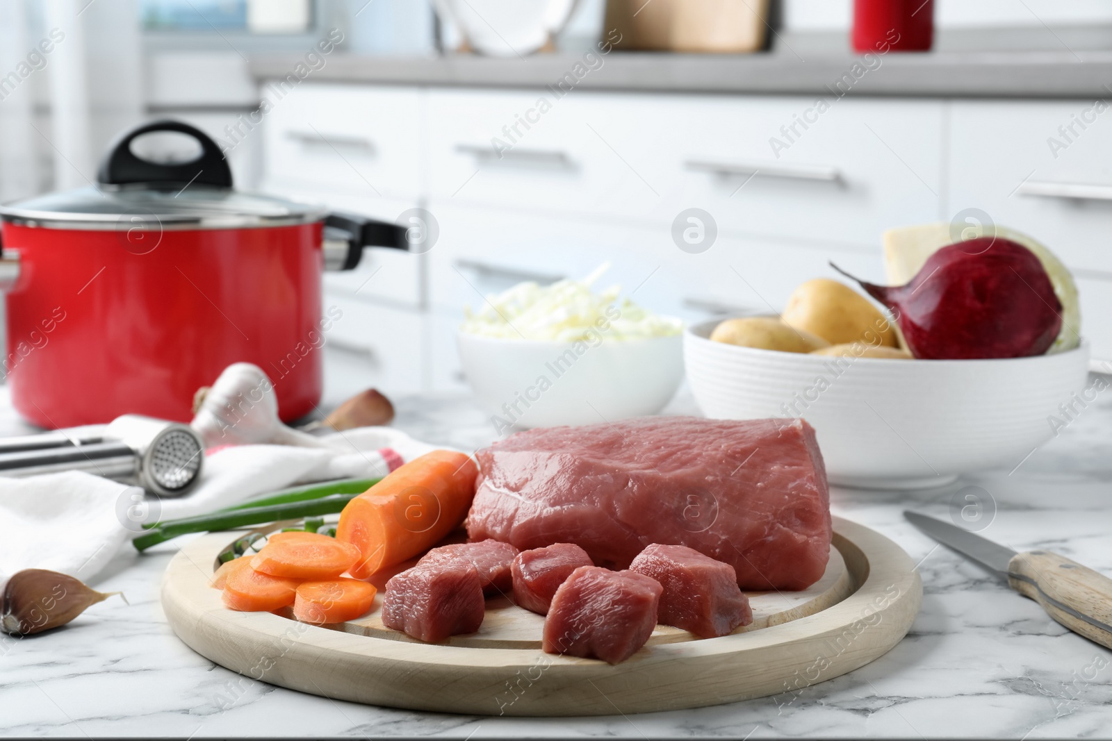 Photo of Fresh ingredients for borscht on white marble table indoors