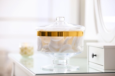 Photo of Jar with cotton pads on dressing table indoors