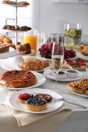 Variety of snacks on white marble table in buffet style indoors