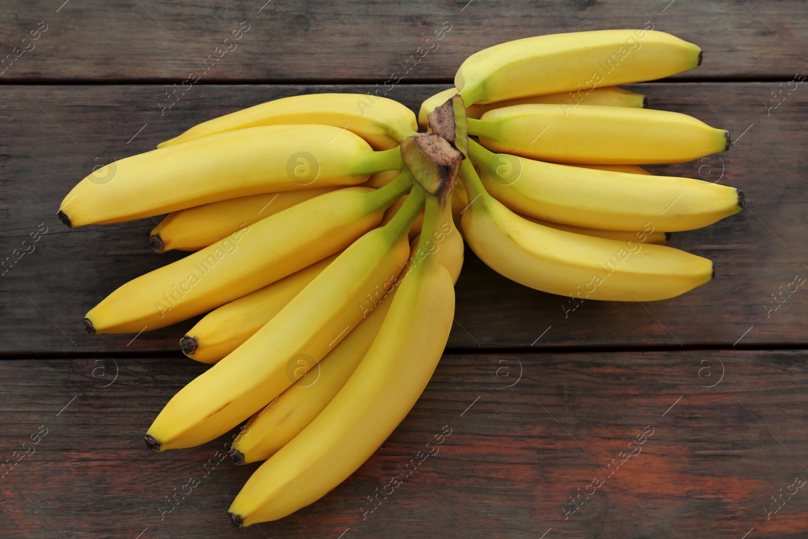 Photo of Ripe yellow bananas on wooden table, flat lay