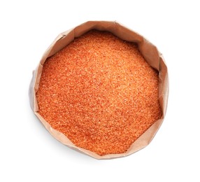 Orange salt in paper bag isolated on white, top view