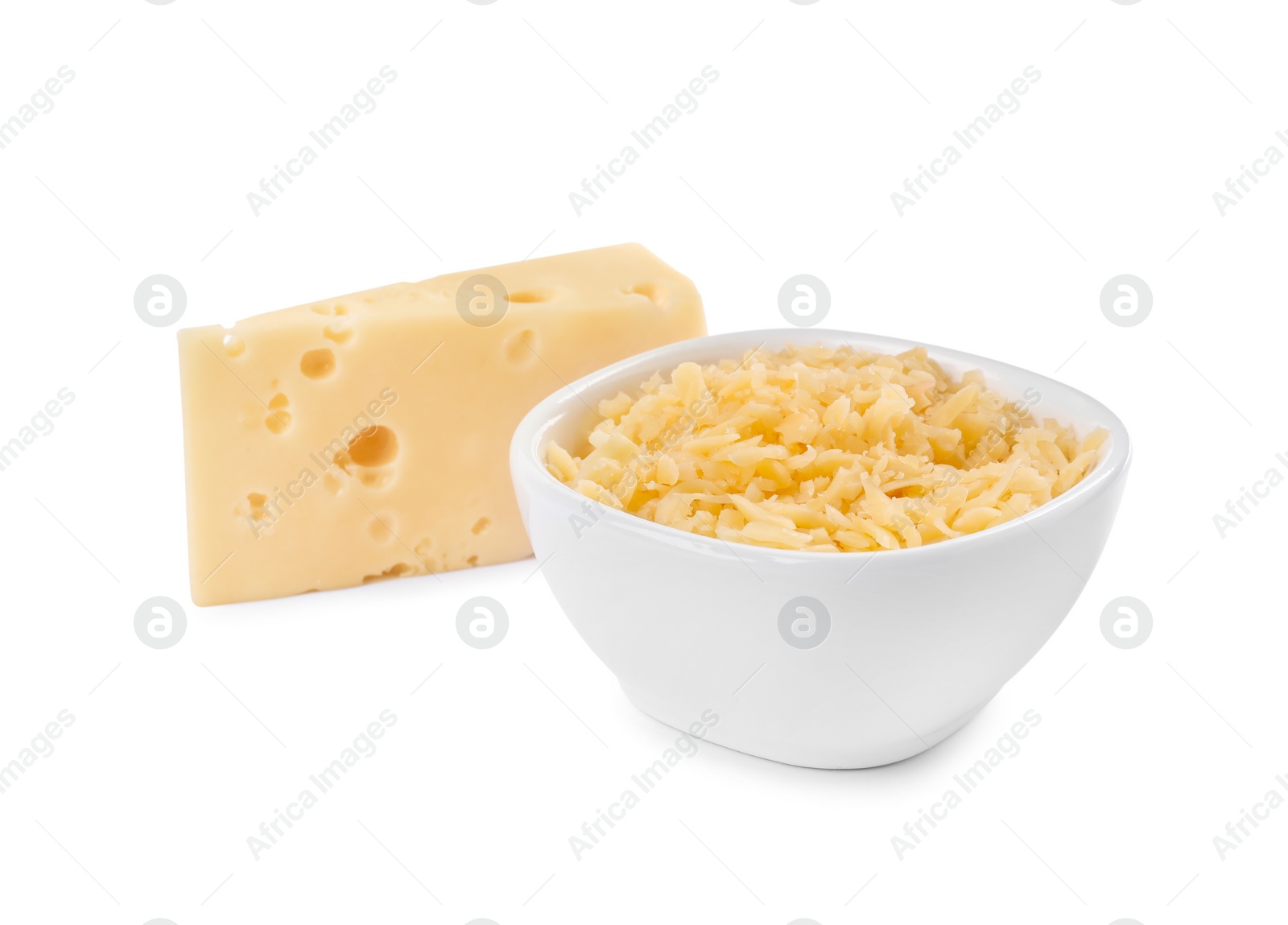 Photo of Grated cheese in bowl and piece of one isolated on white