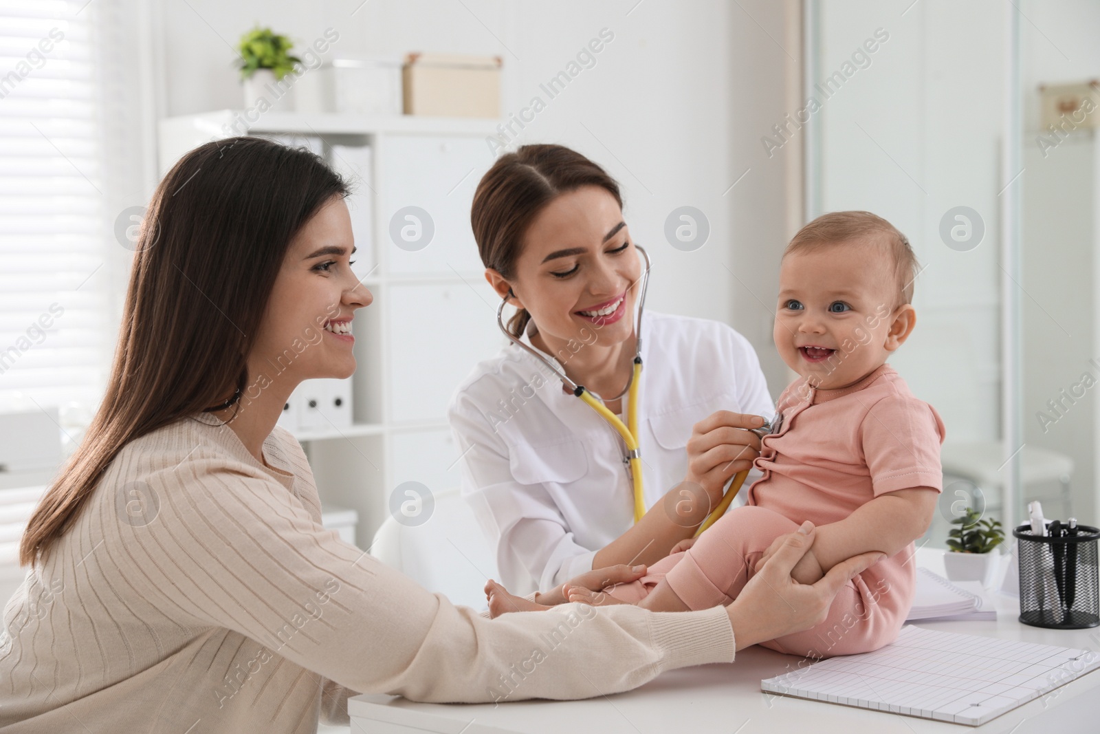 Photo of Mother with her cute baby visiting pediatrician in clinic