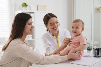 Mother with her cute baby visiting pediatrician in clinic