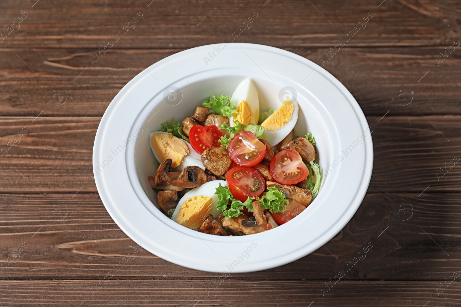 Photo of Plate with delicious fresh salad on table