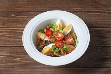 Photo of Plate with delicious fresh salad on table