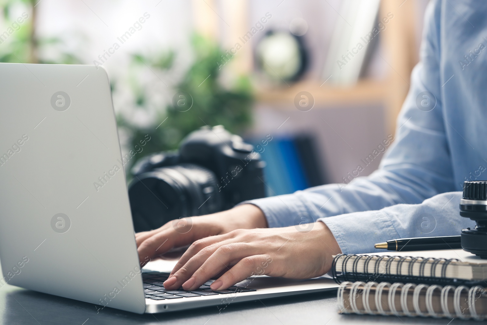 Image of Journalist working with laptop at table, closeup