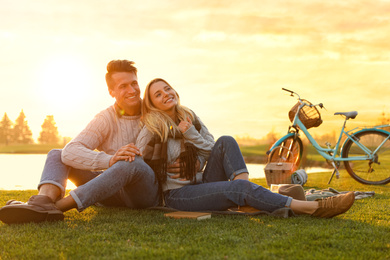 Happy young couple spending time together on picnic outdoors