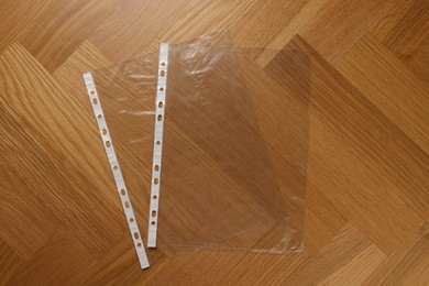 Photo of Punched pockets on wooden table, flat lay