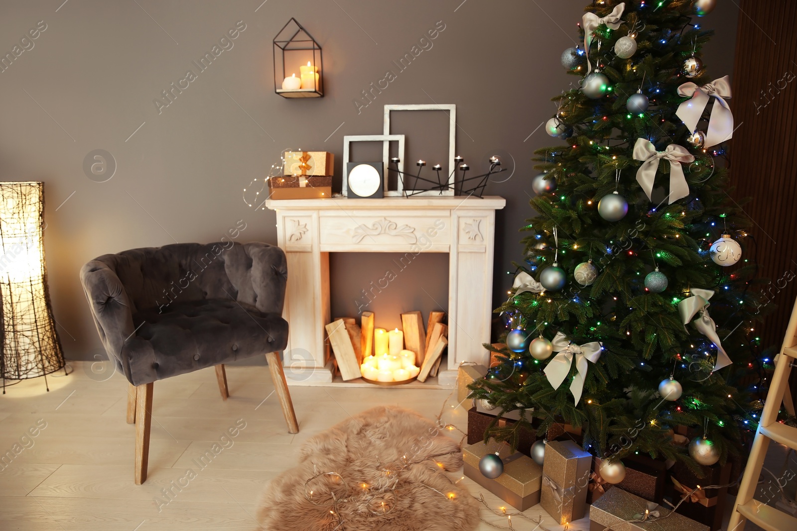 Photo of Stylish room interior with Christmas tree and decorative fireplace