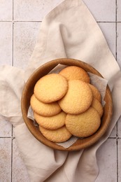 Photo of Delicious Danish butter cookies on white tiled table, top view
